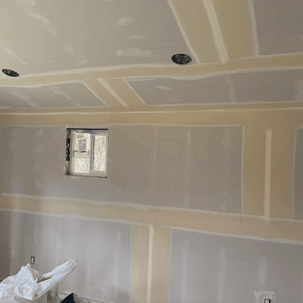 Drywall hung, taped and mudded, ready for paint.